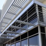 Stadium Logistics Center | Anodized Atlas Canopy Integrated with Louvered Sunshades