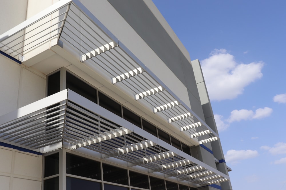 Stadium Logistics Center | Anodized Atlas Canopy Integrated with Louvered Sunshades